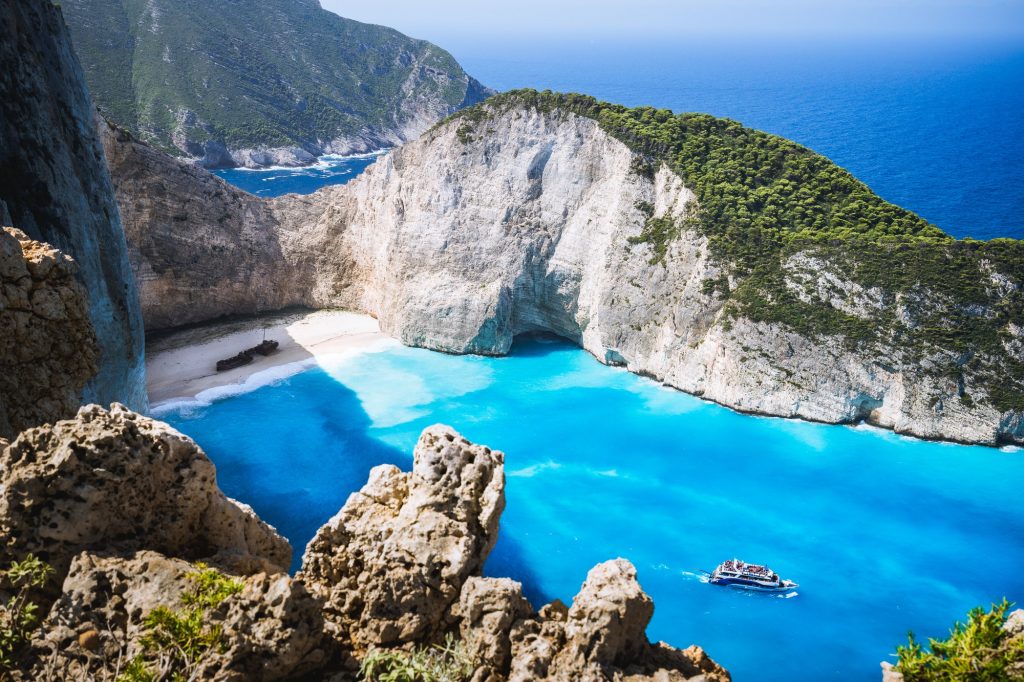 Navagio beach or Shipwreck bay with turquoise water and pebble white beach. Famous landmark location